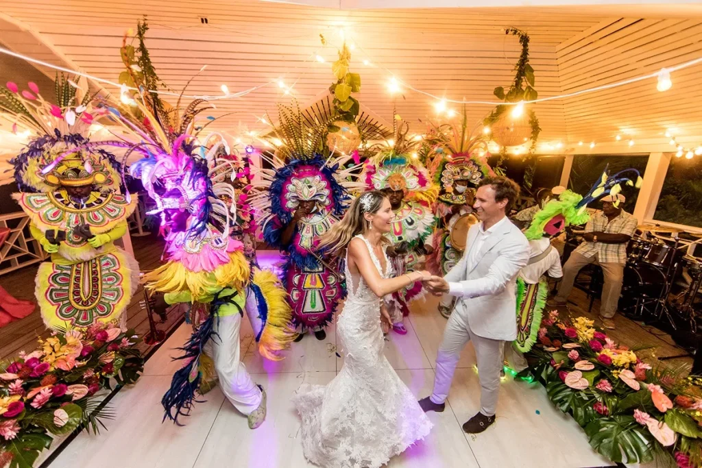 newlyweds with junkanoo dancers at their bahamas wedding weekend