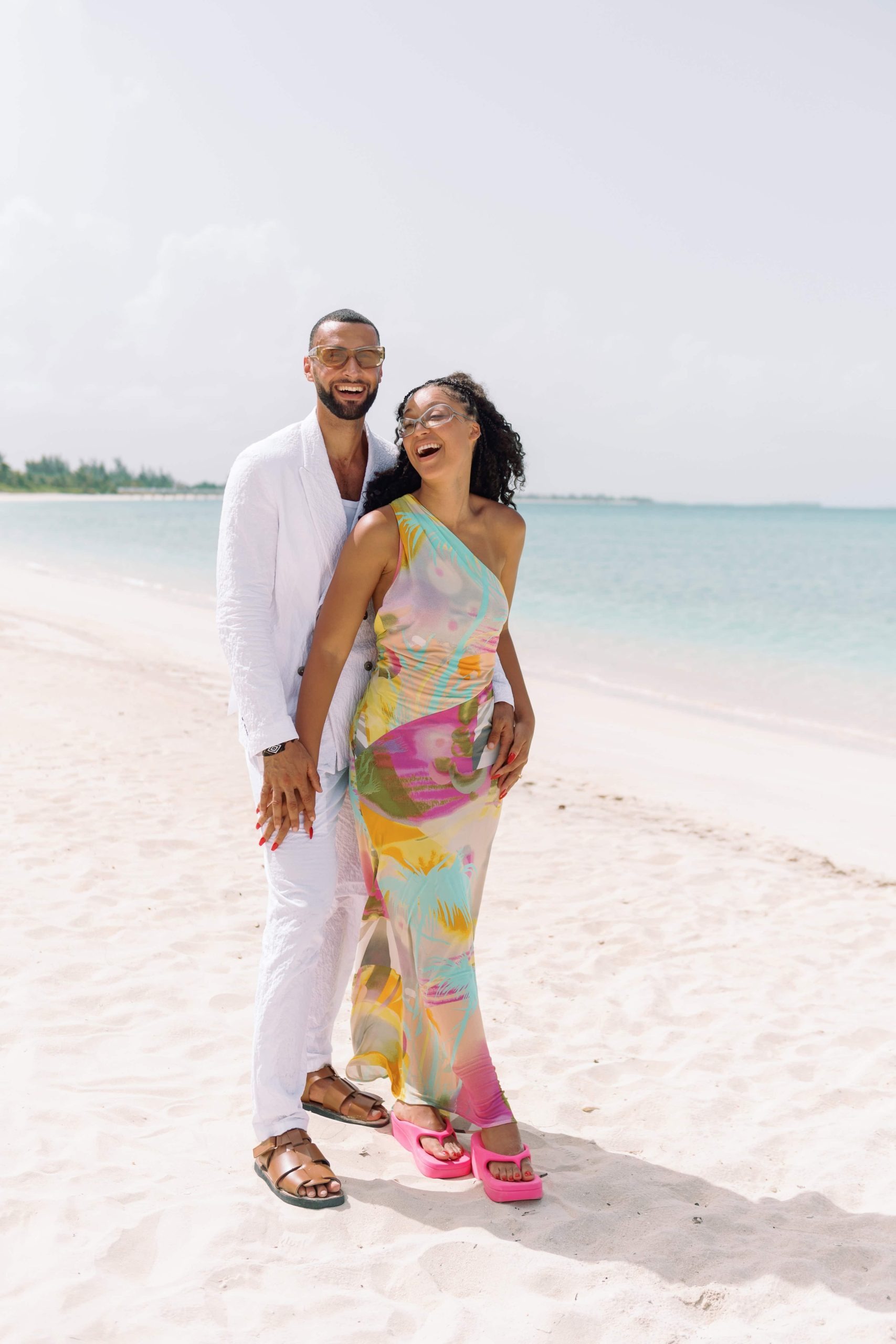 Newlyweds enjoy their Bahamas honeymoon package on the beach