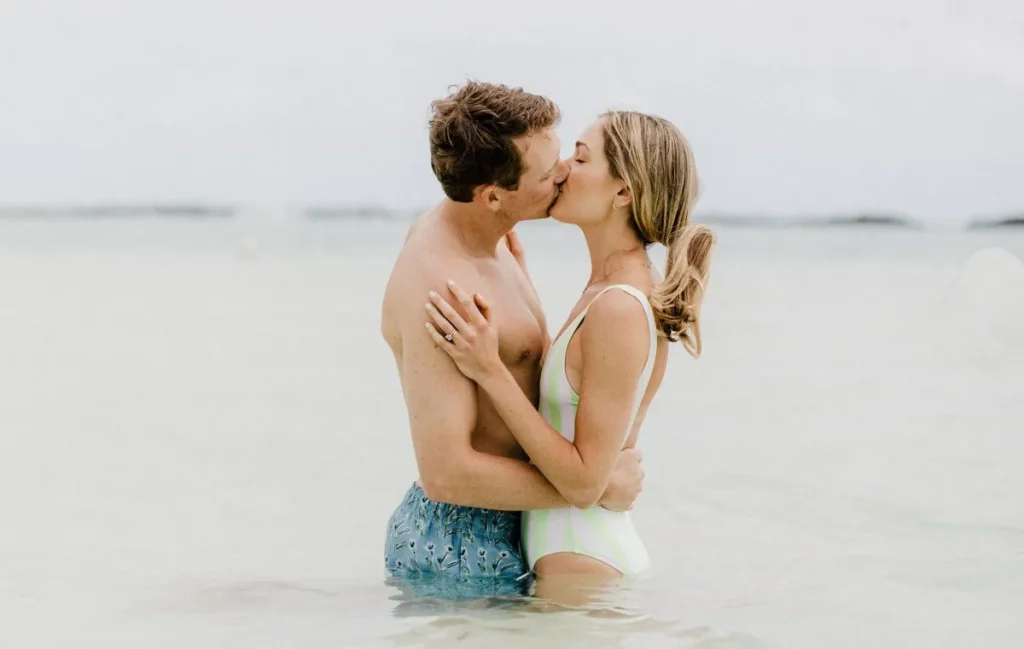 Newlyweds kiss in the water during Bahamas honeymoon